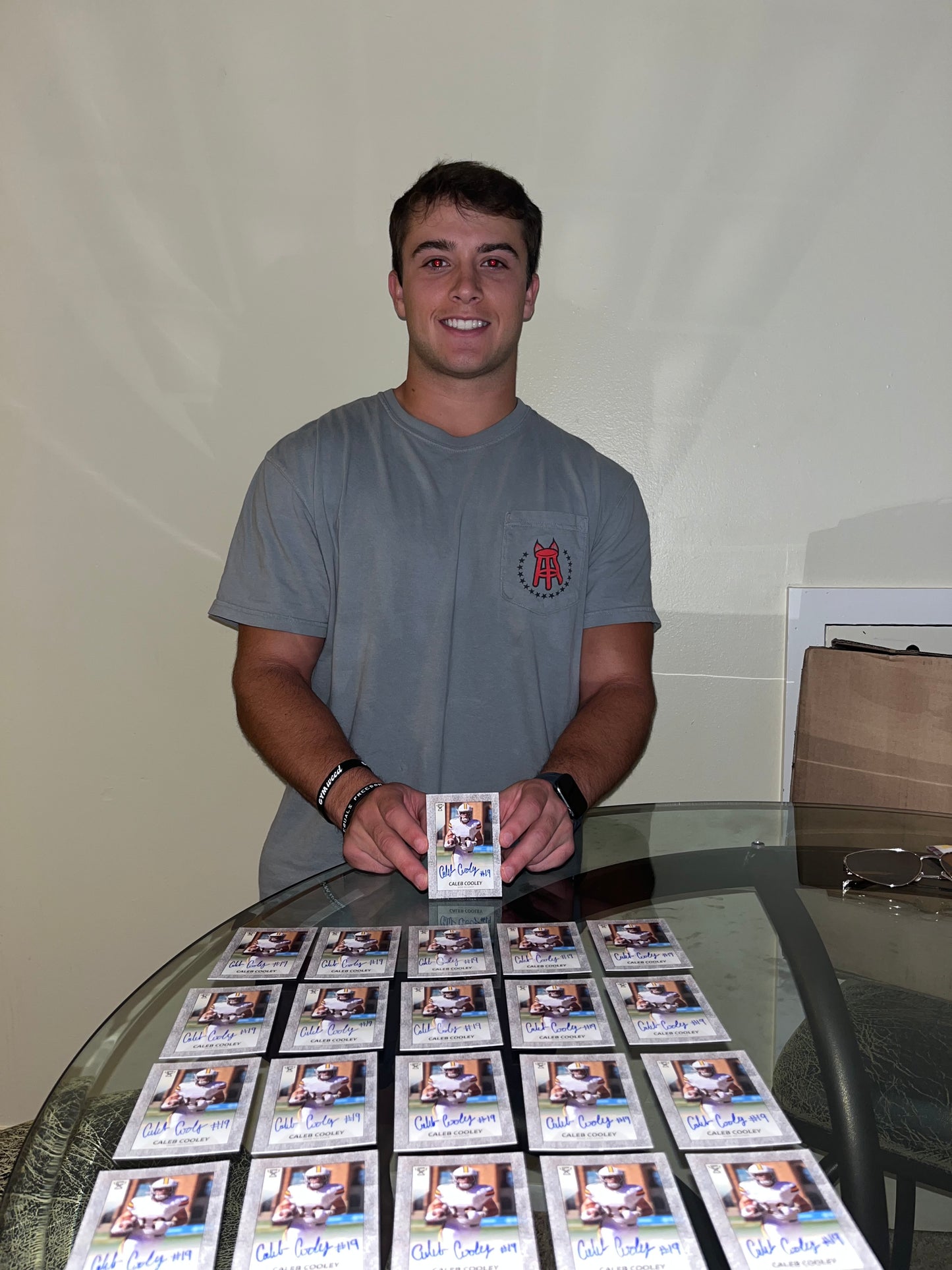 Caleb Cooley signing his limited edition autographed football cards.
