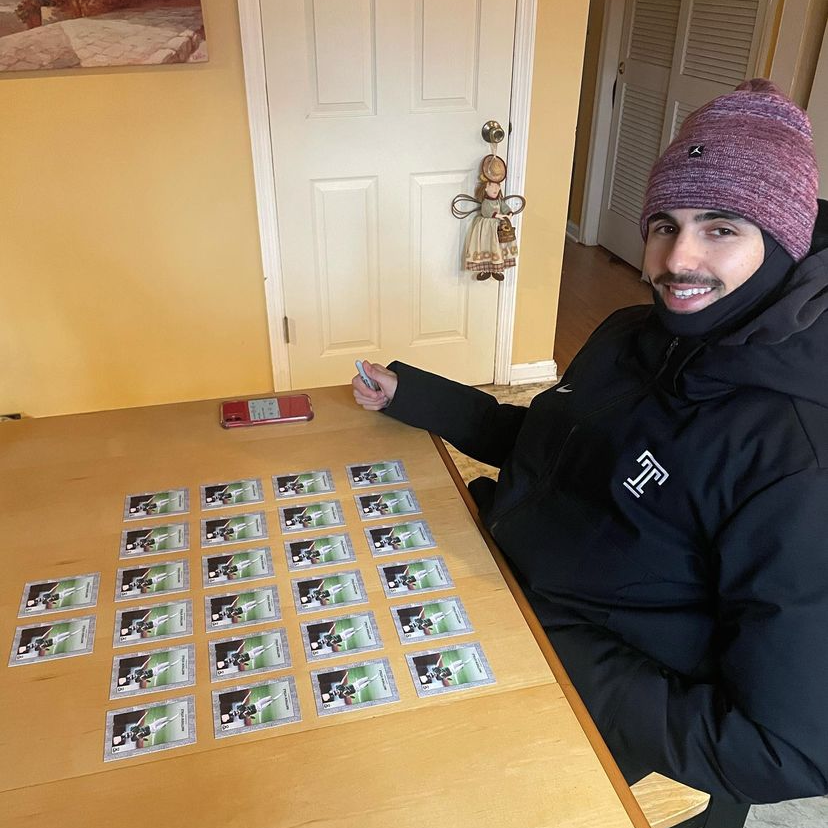 Matthew Vitale autographing trading cards.